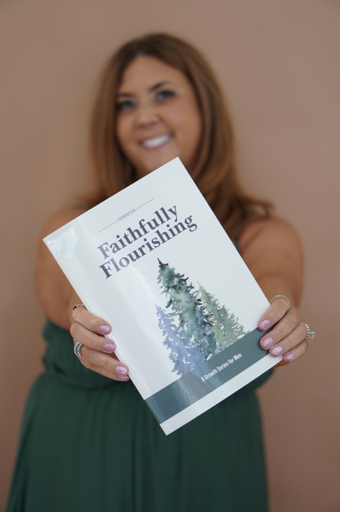 Ginger Steg holding the Faithfully Flourishing growth series book